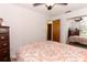 Bright bedroom with a patterned comforter, ceiling fan and mirrored closet doors at 854 Escabar Dr, Altamonte Springs, FL 32714