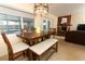 Dining area with wood table, chairs, bench, and views of the pool at 854 Escabar Dr, Altamonte Springs, FL 32714