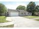 Charming single-story home featuring a two-car garage, well-manicured lawn, and inviting curb appeal at 854 Escabar Dr, Altamonte Springs, FL 32714