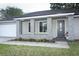 Inviting front porch with stone accents, fresh flowers, and a welcoming entryway at 854 Escabar Dr, Altamonte Springs, FL 32714