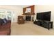 Bright living room with stone fireplace, large TV, and access to outdoor patio at 854 Escabar Dr, Altamonte Springs, FL 32714