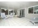 Enclosed patio featuring tile floors, outdoor seating, and access to the backyard at 854 Escabar Dr, Altamonte Springs, FL 32714