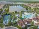 Aerial view of a community pool, lake, and houses at 8808 Macapa Dr, Kissimmee, FL 34747