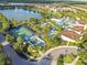 Aerial view showcasing the community basketball court, lazy river, pool and surrounding homes near the lake at 8808 Macapa Dr, Kissimmee, FL 34747