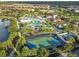 Aerial view of the community with basketball court, lazy river, pool, and residential homes at 8808 Macapa Dr, Kissimmee, FL 34747