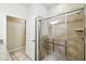 Bathroom with tiled shower, glass door, and granite countertop at 8808 Macapa Dr, Kissimmee, FL 34747
