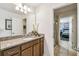 Bright bathroom with granite countertop vanity, undermount sink, and partial view of the walk-in shower and bedroom at 8808 Macapa Dr, Kissimmee, FL 34747