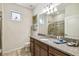 Bright bathroom with granite countertop, tiled floor, toilet, and mirror at 8808 Macapa Dr, Kissimmee, FL 34747