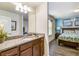 Well-lit bathroom boasts granite countertops, an undermount sink, and a partial view into the bedroom at 8808 Macapa Dr, Kissimmee, FL 34747