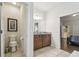 Bright bathroom with a vanity, toilet, and doorway leading to a bedroom with staircase at 8808 Macapa Dr, Kissimmee, FL 34747