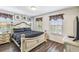 Bedroom featuring a patterned bedspread, wood-look flooring, and lots of natural light at 8808 Macapa Dr, Kissimmee, FL 34747