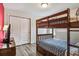Bedroom featuring a wooden bunk bed with blue bedding and drawers and wood-look flooring at 8808 Macapa Dr, Kissimmee, FL 34747