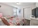 Cozy bedroom featuring two floral beds, ample closet space, and a window with a patterned valance at 8808 Macapa Dr, Kissimmee, FL 34747