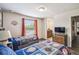 Bright bedroom showcases two twin beds, a window with vibrant curtains, and access to a full ensuite bathroom at 8808 Macapa Dr, Kissimmee, FL 34747