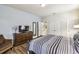 Comfortable bedroom boasts a dresser, chair, and a queen bed with black and white bedding at 8808 Macapa Dr, Kissimmee, FL 34747