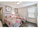 Charming bedroom with two floral beds, a butterfly-themed window valance, and hardwood floors at 8808 Macapa Dr, Kissimmee, FL 34747
