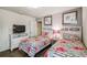 Bright bedroom boasts two floral beds, stylish decor, and a tv, creating a welcoming space at 8808 Macapa Dr, Kissimmee, FL 34747