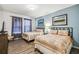 Bedroom featuring two beds with an accent wall, hardwood floors, and natural light at 8808 Macapa Dr, Kissimmee, FL 34747