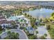 Aerial view showcasing the community pool, lounging area, and beach volleyball court by the lake at 8808 Macapa Dr, Kissimmee, FL 34747