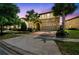 Beautiful two-story home featuring a stone facade, manicured landscaping, and a spacious two-car garage at 8808 Macapa Dr, Kissimmee, FL 34747