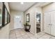 Bright foyer with neutral tile flooring, decorative accents, and a view into an adjacent bedroom at 8808 Macapa Dr, Kissimmee, FL 34747