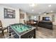 Large game room with a foosball table, adjacent to a dining area, and large living space at 8808 Macapa Dr, Kissimmee, FL 34747