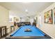 A pool table is the focal point of this game room with a large living area off in the distance at 8808 Macapa Dr, Kissimmee, FL 34747