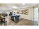 Bright game room boasts a pool table, neutral walls, and luxury vinyl plank flooring at 8808 Macapa Dr, Kissimmee, FL 34747