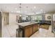 Open-concept kitchen and dining area with tile floors and island with sink at 8808 Macapa Dr, Kissimmee, FL 34747