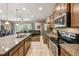 Open kitchen featuring granite counters, stainless appliances, and seamless flow into the living area at 8808 Macapa Dr, Kissimmee, FL 34747