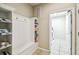 Functional mud room featuring built-in storage, hooks, and access to the laundry area at 8808 Macapa Dr, Kissimmee, FL 34747