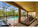 Covered patio with lounge chairs, a barbecue, brick tiles and views of the screened-in pool area at 8808 Macapa Dr, Kissimmee, FL 34747