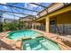 Screened-in pool area featuring a pool, in-ground hot tub, and brick-tile patio with plants at 8808 Macapa Dr, Kissimmee, FL 34747