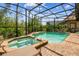 Screened-in pool area featuring a pool, in-ground hot tub and a brick-tile patio with plants and a lounge chair at 8808 Macapa Dr, Kissimmee, FL 34747