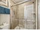 Bathroom featuring a shower with sliding glass doors and beige tiled walls and a handheld shower head at 8808 Macapa Dr, Kissimmee, FL 34747