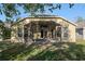 Back exterior view of house with large screened patio at 9723 Pecky Cypress Way, Orlando, FL 32836