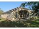 Back exterior view of the house with a screened patio at 9723 Pecky Cypress Way, Orlando, FL 32836