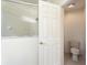 Modern bathroom with a glass-enclosed shower and a separate toilet area at 9723 Pecky Cypress Way, Orlando, FL 32836
