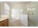 Bright bathroom with a soaking tub, a glass-enclosed shower, and a tiled floor at 9723 Pecky Cypress Way, Orlando, FL 32836
