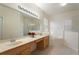 Bathroom featuring double sinks, a large mirror, a soaking tub, and a glass-enclosed shower at 9723 Pecky Cypress Way, Orlando, FL 32836