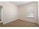 This bedroom features neutral walls, carpet, and a window with blinds for a serene and comfortable space at 9723 Pecky Cypress Way, Orlando, FL 32836