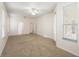 Bright bedroom with neutral carpet and a ceiling fan, offering ample space and natural light at 9723 Pecky Cypress Way, Orlando, FL 32836