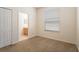 Cozy bedroom with a window and an en-suite bathroom, providing comfort and privacy for residents at 9723 Pecky Cypress Way, Orlando, FL 32836