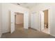 Spacious bedroom with double doors, closet, and access to an ensuite bathroom for added privacy and convenience at 9723 Pecky Cypress Way, Orlando, FL 32836