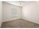 Bedroom with neutral carpet, window, ceiling fan and base molding at 9723 Pecky Cypress Way, Orlando, FL 32836
