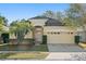 Charming single-story home with well-maintained landscaping and a two-car garage at 9723 Pecky Cypress Way, Orlando, FL 32836
