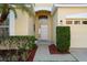Close up of the front door with decorative plants and mulch landscaping at 9723 Pecky Cypress Way, Orlando, FL 32836