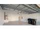 Spacious garage with white brick walls and grey floor at 9723 Pecky Cypress Way, Orlando, FL 32836