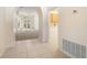 Hallway with tile flooring that leads to the living room and other areas of the home at 9723 Pecky Cypress Way, Orlando, FL 32836