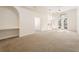 Bright living room with high ceilings, an arched window, and ample space for relaxation and entertaining at 9723 Pecky Cypress Way, Orlando, FL 32836